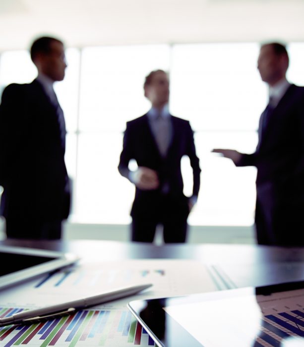 Colleagues meeting to discuss their future financial plans, only silhouettes being viewed